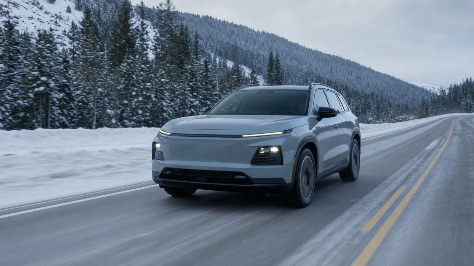 Extended-range electric SUV driving on a snowy northern highway